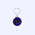 Top view of a round enamel pet ID tag featuring a curled black cat on dark blue background - 2.5cm / Purple Cat