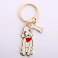 Golden metal poodle keychain with red scarf and bone charm on white background - Gold Bedlington Terrier