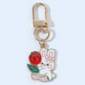 Detail of a white rabbit enamel keychain holding a red rose with golden lobster clasp - Flower Rabbit with Clasp