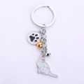 Cute white cat keychain with pink ears, paw pendant and golden bells for gift charms - White Cat