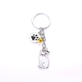 Cat keychain with white enamel feline pendant, black paw print charm and colorful bells - White Bobtail Cat