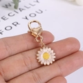 Dettaglio del portachiavi a margherita con chiusura a moschettone a cuore dorato - Crisantemo Bianco