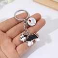 Handheld photo of a Schnauzer dog keychain with a red collar and I Love Dogs charm - Black Schnauzer + Heart