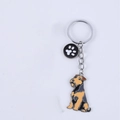 Cartoon terrier dog keychain in brown and black finish with a small black paw charm - New Yorkshire Terrier