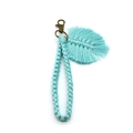 Detailed close-up of mint green handmade woven wristlet keychain with a macrame leaf charm - 2*18cm / Light Blue