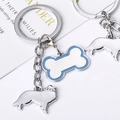 Porte-clés os de chien argenté avec bord en émail bleu et breloque chien en strass - Sheltie Os / 10cm