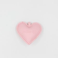Pink heart-shaped faux leather keychain charm with embossed letters and double stitching - Pink