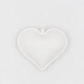 Detailed view of a white PU leather heart charm with decorative white stitching accents - White