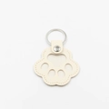 Cute cream leather cat paw keychain with silver metal ring and hollow cutout design - Beige