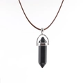 Detail of a polished black hexagonal crystal stone pendant with silver metal bail clasp - Black