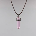 Close-up of pink hexagonal crystal pendant with silver clasp on brown wax cord - Red Crystal