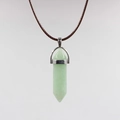 Detailed macro view of light green hexagonal crystal pendant with silver clasp on cord - Aventurine Green