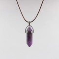 Macro detail of hexagonal purple amethyst crystal pendant with silver clasp and cord - Purple Crystal