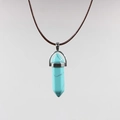 Detail of hexagonal turquoise crystal pendant with silver clasp and brown braided cord - Turquoise
