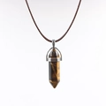 Macro detail of hexagonal tiger eye stone pendant with brown braided wax cord necklace - Tigers Eye