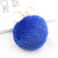 Detailed view of fluffy royal blue faux rabbit fur pom pom with gold lobster clasp - Sapphire Blue
