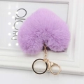 Close-up of fluffy purple heart-shaped plush keychain with golden lobster clasp and ring - Light Purple