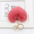 Close-up of a pink heart-shaped plush keychain with a gold metal lobster clasp - Brick Red