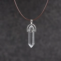 Macro view of hexagonal clear crystal pendant with silver setting and brown wax cord - White Crystal