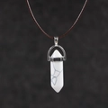 Detailed view of hexagonal white turquoise pendant with silver clip and brown wax cord - Howlite