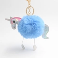 Close-up of blue plush unicorn keychain with iridescent silver details and gold hardware - Blue