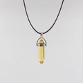 Detail of a yellow hexagonal crystal pendant with a silver metal clasp on a brown cord necklace - Yellow