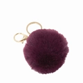 Detailed view of plush plum purple faux fur ball with golden circular keyring and lobster clasp - Dark Purple