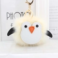 Cute yellow plush penguin keychain with golden metal clasp and fluffy faux fur texture - Off White