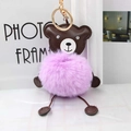 Detail of cute purple plush bear keychain with soft faux fur and gold metal clasp - Violet