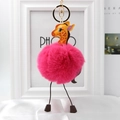 Detail view of a bright rose red faux fur pompom keychain with a cute giraffe head charm - Rose Red