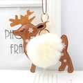 Close-up of reindeer faux fur keychain with gold antlers and white snowflake details - Off-white