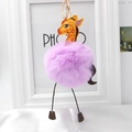 Detailed view of purple plush giraffe keychain with yellow leather head and golden metal clasp - Violet