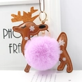 Macro detail of reindeer bag charm featuring purple faux fur pompom and golden glitter antlers - Violet