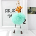Detail of giraffe plush keychain with mint green faux fur pompom and golden lobster clasp - Mint Green