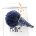 Detailed close-up of dark blue ice cream pompom keychain with gold lobster clasp - Navy Blue