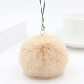 Close-up of soft apricot faux rabbit fur pom pom pendant with silver metal lobster clasp - Khaki
