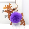 Detail view of brown leather reindeer keychain with purple faux fur pompom and gold antlers - Purple