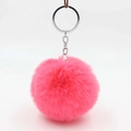 Close-up of fluffy magenta faux rabbit fur pom pom with silver metal keychain ring - Watermelon red
