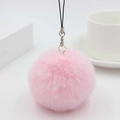 Macro view of pink faux rabbit fur pom pom keychain with black lanyard and lobster clasp - Light Pink