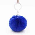 Close-up of fluffy royal blue faux fur pompom keychain with polished silver metal ring - Sapphire Blue
