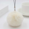 Close-up of fluffy off-white faux fur ball keychain with metal clasp and black lanyard - Off White
