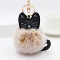 Detail view of a cat plush keychain with brown faux fur ball and golden metal clasp - Khaki And White With Gold Ring