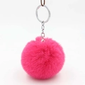 Close-up of fluffy rose red faux rabbit fur pom pom keychain with silver metal clasp - Rose Gold