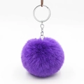 Macro view of a 8cm fluffy purple faux rabbit fur pompom with silver metal keychain - Purple
