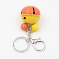 Close-up of star cutout bells keychain with orange and yellow dual-tone metal finish - Orange