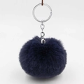 Close-up of fluffy navy blue faux rabbit fur pompom keychain with silver metal ring - Navy Blue