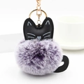 Detail of cute purple fluffy cat keychain with golden metal clasp and black feline ears - Purple And White With Gold Ring
