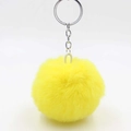 Close-up of bright yellow fluffy faux fur pompom keychain with silver metal ring and chain - Yellow