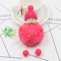 Close-up of fluffy pink sleeping baby plush pom pom keychain with gold lobster clasp - Watermelon red