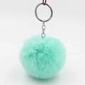 Detail of mint green plush ball keychain with high-quality silver metal ring connector - Light Green